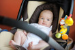 Little baby playing in a carseat