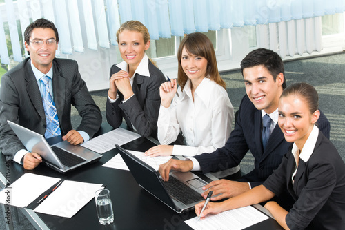 Photo: Successful business-team planning or brainstorming at office Successful business-team planning or brainstorming at office