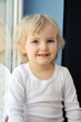 girl sits at  window
