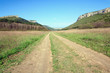 Spring Crimean mountain landscape with road in valley (Mangup Ka Spring Crimean mountain landscape with road in valley (Mangup Ka