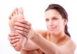 Young woman massages her foot