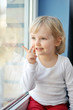 girl sits at  window