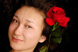 Beautiful young asian girl face with a red rose