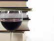 stack of books with a glass of wine