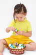little girl holding easter eggs