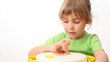 small girl counts multi-coloured buttons in toy on white