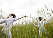 Two girls fencing in a field