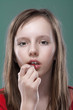 girl putting on makeup