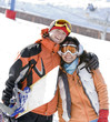 Lucky couple  snowboarders  in a mountain valley