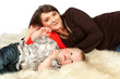 Smiling mother lying with her son in sheep's clothing