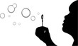 A Silhouette of a young girl blowing bubbles A Silhouette of a young girl blowing bubbles
