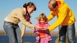 family stands and considers something in palms