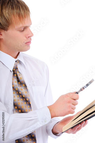 Photo: Young man with magnifier by read book Young man with magnifier by read book