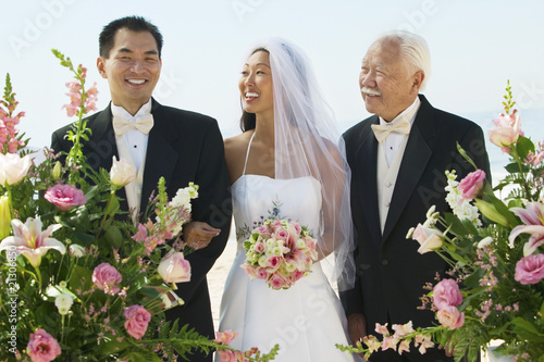 Photo: bride and groom with father outdoors bride and groom with father outdoors