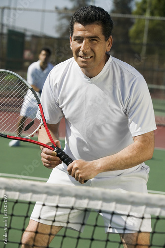 Photo: male doubles tennis players waiting for serve front view focus on foreground male doubles tennis players waiting for serve front view focus on foreground