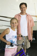 Father with Daughter on Bike Next to RV