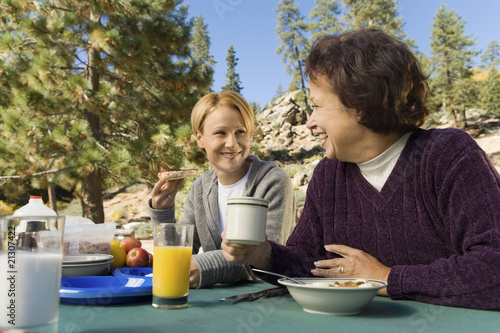 Photo: Women Sitting at Picnic Table Women Sitting at Picnic Table