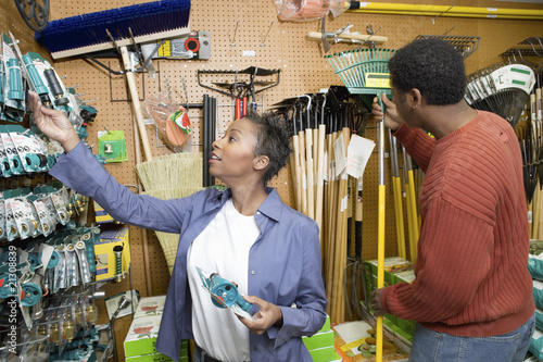 Photo: couple selecting garden tools in shop couple selecting garden tools in shop