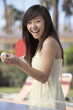 woman in summer dress playing ping pong