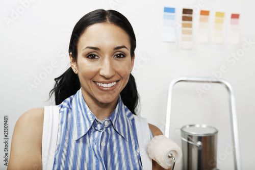 Photo: woman holding small paint roller portrait woman holding small paint roller portrait