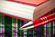 Red check book and pen Red check book and pen