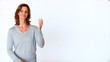 Happy mature woman showing you empty space