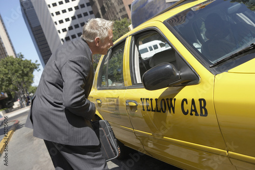 Photo: businessman talking to taxi driver businessman talking to taxi driver
