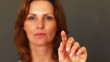 Mature woman touching the screen and selecting