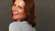 Happy mature woman smiling and turing around