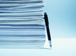 Fountain pen leaning against stack of paper