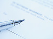 Tip of fountain pen laying on paper