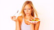 Pretty young woman eating fruits