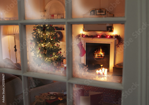 Photo: Christmas tree in living room behind window Christmas tree in living room behind window