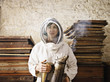 Beekeeper holding smoker