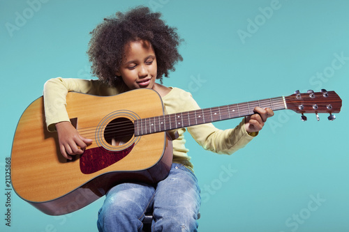 Photo: Girl playing acoustic guitar Girl playing acoustic guitar