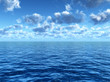 cloudy blue sky above a blue surface of the sea