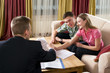 Happy couple meeting with agent at home