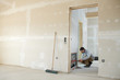 plumber at the heating circuit distributor in a building fabric