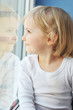 girl sits at  window