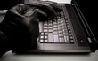 Mad hacker working on laptop at night