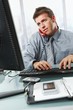 Businessman calling typing in office Businessman calling typing in office