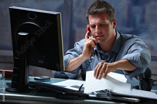 Photo: Businessman on call in overtime Businessman on call in overtime