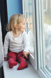 girl sits at  window