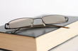 Book and Glasses isolated on white