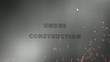 Laser writing "under construction" on metal plate.