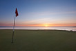 Sunrise over the sea from a golf green