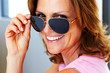 Happy young woman looking through goggles