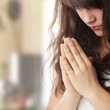 Young caucasian woman praying