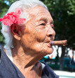 Old wrinkled woman smoking cigar