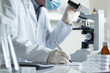 Scientist conducting research with microscope